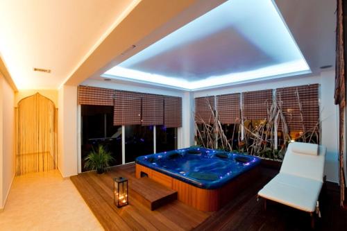 a living room with a large tub in the middle of the room at Castello Di Cavallieri Suites & Spa - Adults Only in Faliraki