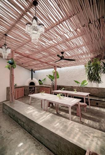 a restaurant with two tables and a chandelier at Hacienda Villa Watukarung in Watukarung
