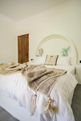 a bedroom with a bed with a blanket on it at Hacienda Villa Watukarung in Watukarung