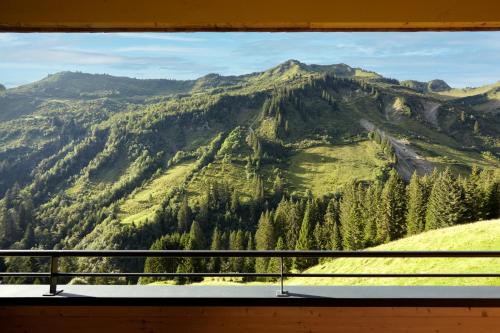 a view of a mountain from a window at Alpenstolz Damüls Haus 4 - Stilvoll urlauben in den Bergen in Damuls