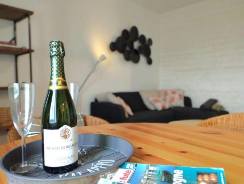 a bottle of champagne sitting on a table with a glass at LACS in Saulieu