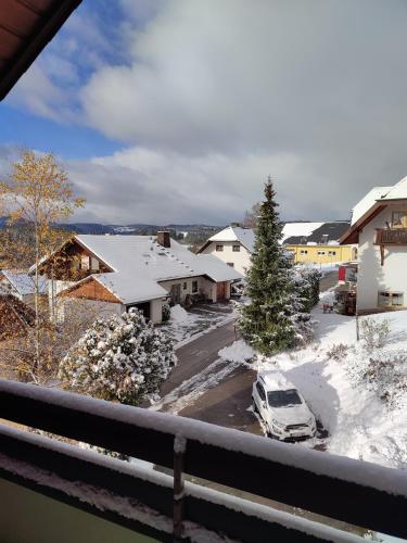 a car parked in a parking lot with snow at Feldbergsicht in Lenzkirch