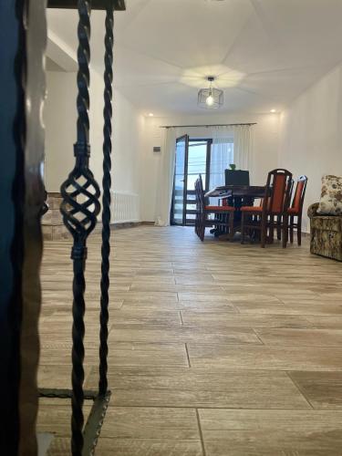a dining room and living room with a table and chairs at La Turcu in Văliug