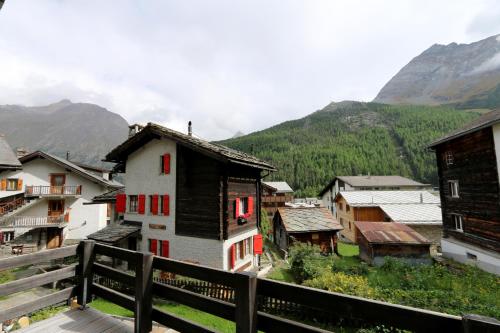 a view of a village with buildings and mountains at Chalet Heimeli in Saas-Fee