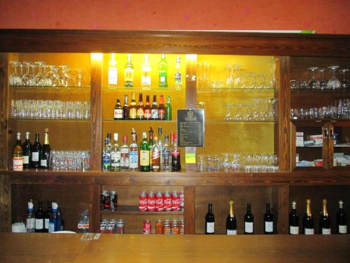 a bar with a lot of bottles of alcohol at Hotel de la Gare Aalst in Aalst