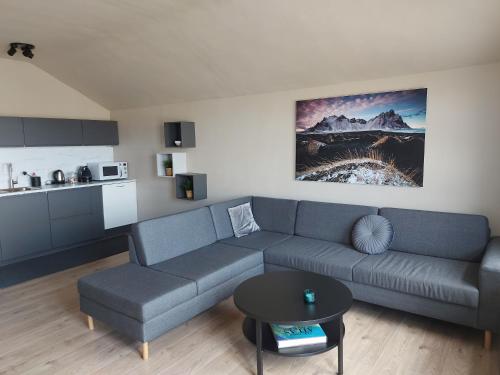 a living room with a couch and a table at Heppa Apartments in Höfn