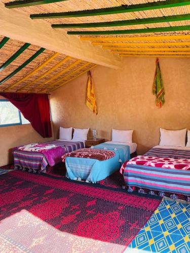 a room with three beds in a room at Bivouac Lot Of Stars in Ouarzazate