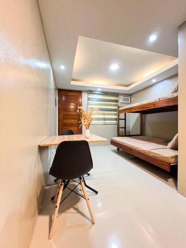 a room with a desk and a bed and a chair at Kâyumanggi Studio in El Nido