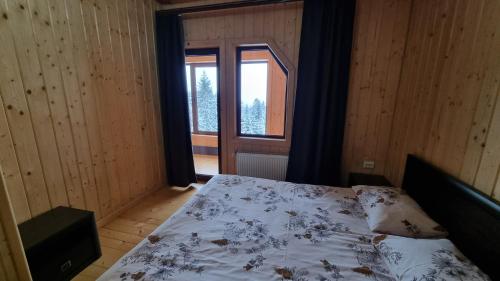 a bedroom with a bed and a large window at SPA Resort Villa Sofia in Yablunytsya