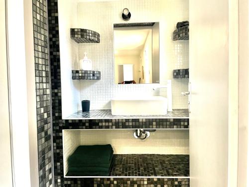 a bathroom with a sink and a mirror at La Sérénade - TOP Destination - Montreuil in Montreuil