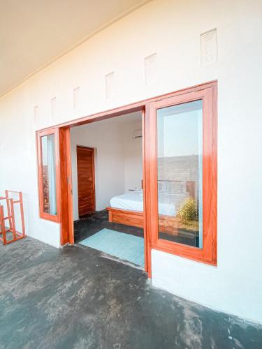 a room with a window with a bed in it at Turtle House Surf & Stay in Airsatang