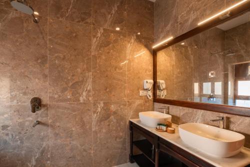 a bathroom with a sink and a mirror at Hotel Helsinki House in Jaisalmer