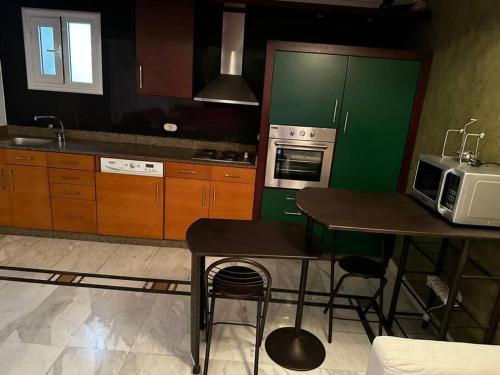 a kitchen with a table and a microwave oven at One - bedroom building 174 in Sharm El Sheikh