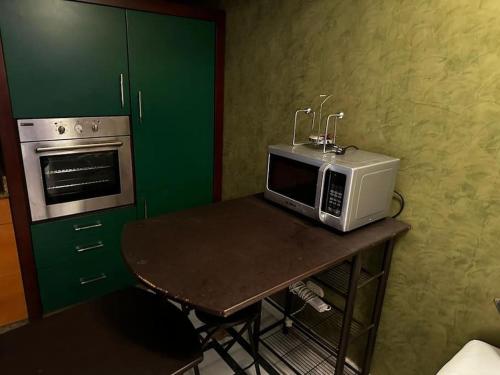 a microwave sitting on a table in a kitchen at One - bedroom building 174 in Sharm El Sheikh