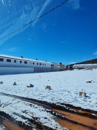 a snow covered ground with a plane in the background at Villa de luxe in Imouzzer Kandar