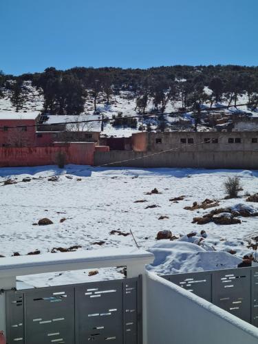 a snow covered field with a building in the background at Villa de luxe in Imouzzer Kandar