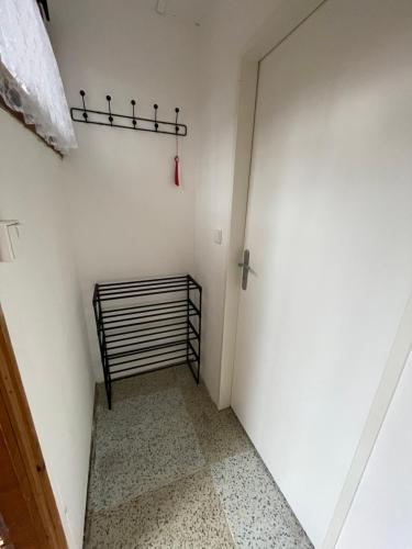 a small room with a white wall and a door at Chata Svoboda in Doksy