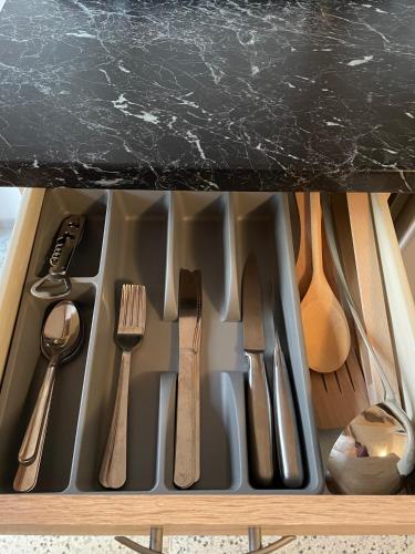a kitchen sink with utensils in a drawer at Chata Svoboda in Doksy