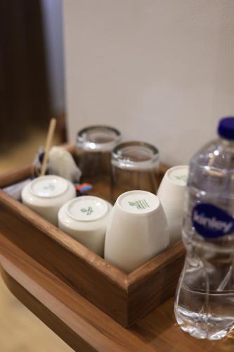 a wooden tray with candles and a bottle of water at Hotel Mahadev Rishikesh in Rishīkesh