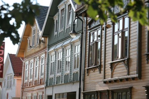 a row of wooden buildings on a street at Grand Hotel Egersund in Egersund