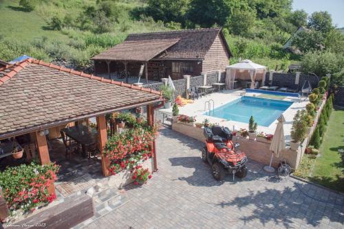 an aerial view of a house with a motorcycle parked next to a pool at Biertan 48 Guesthouse in Biertan