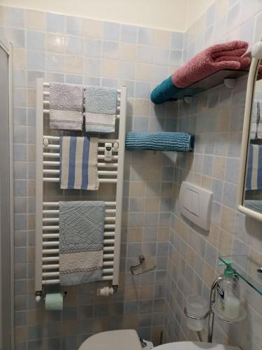 a bathroom with towels hanging on a wall at Appartamento ITACA - CITRA 08065-LT-0722 in Ventimiglia