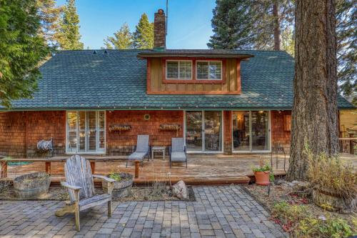 a log home with a patio and trees at Serene 5BDR Near Beach and Forest Trails in Carnelian Bay