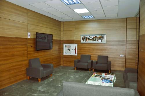 a waiting room with two chairs and a tv at Arena Hotel Goygol in Xanlar