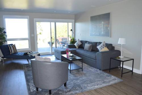 a living room with a blue couch and chairs at 1-Bedroom Seaview Guesthouse on Seattle Luxury Estate with Views of Olympic Mountains in Seattle