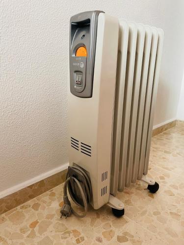 a pay phone sitting next to a radiator at Apartamento Conil Centro y Playa, descanso perfecto, con aire acondicionado y WIFI in Conil de la Frontera