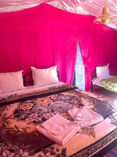 a bedroom with a bed with a pink tent at Bivouac Lot Of Stars in Ouarzazate