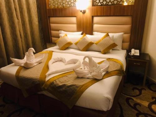 a hotel room with a bed with towels on it at Al Andalus Palace 1 Hotel in Al Madinah
