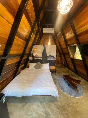 a bedroom with a bed in a wooden room at Tiên Sơn Pleiku Homestay in Pleiku