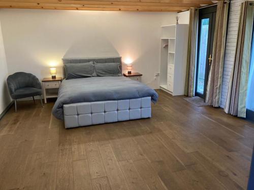 a bedroom with a large bed and a wooden floor at The Bolt Hole - Looe. in Looe