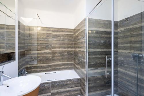 a bathroom with a shower and a sink at Luxury Top Floor Sea View Apartment in Villefranche sur Mer in Villefranche-sur-Mer
