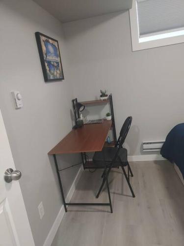 a desk with a chair in a room at Oasis of Happiness in Saskatoon
