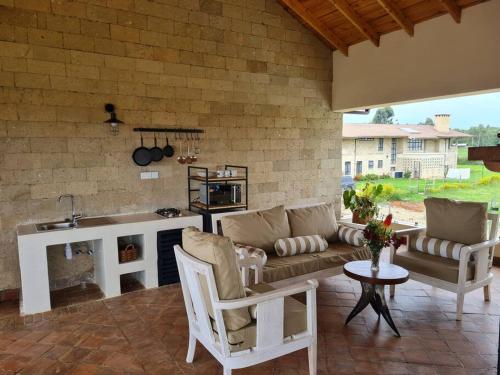 a living room with a couch and a table at The Landing Cottages in Nanyuki