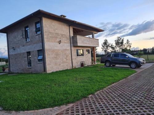 a truck parked in front of a brick house at The Landing Cottages in Nanyuki