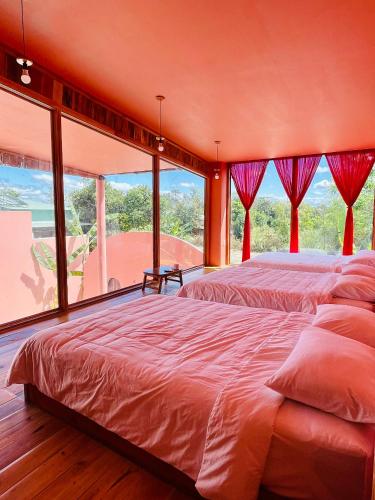 a bedroom with two beds and a large window at Tiên Sơn Pleiku Homestay in Pleiku