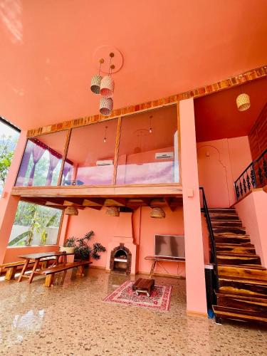 a large room with a staircase and a living room at Tiên Sơn Pleiku Homestay in Pleiku