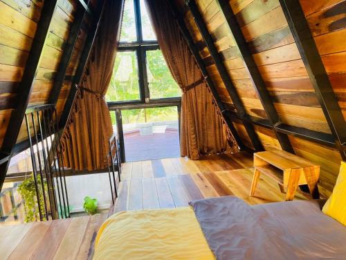 a bedroom with a bed and a large window at Tiên Sơn Pleiku Homestay in Pleiku