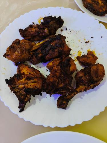 a plate of fried food on a table at Thekkumbath Sea Breeze Pool villa in Kannur