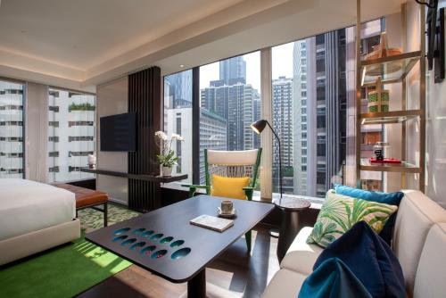 a living room with a view of a city at Hotel Indigo Kuala Lumpur on the Park by IHG in Kuala Lumpur