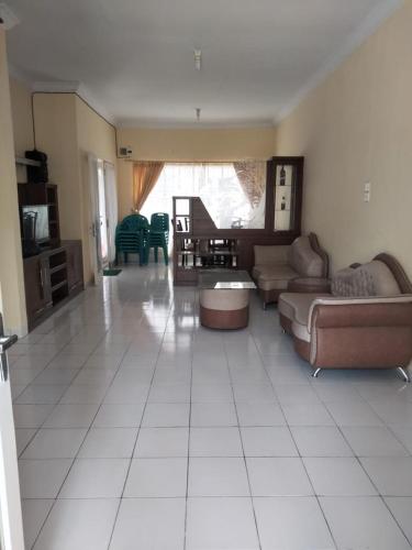 a large living room with a couch and a table at Villa Highland No 8 Berastagi View in Berastagi