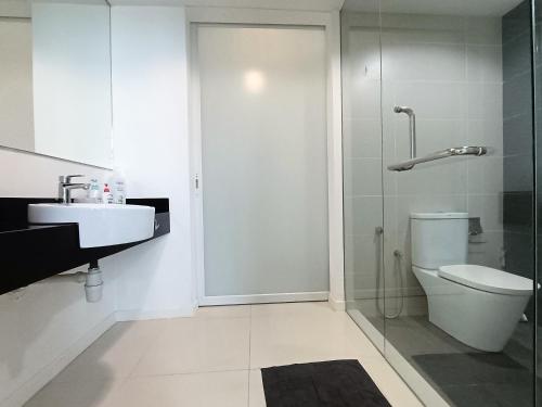 a bathroom with a shower and a toilet and a sink at Tropicana Suite in Petaling Jaya