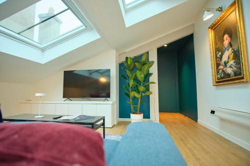 a living room with a ceiling with skylights at Le Louis XVI - Loft in the clouds in the heart of Nancy in Nancy