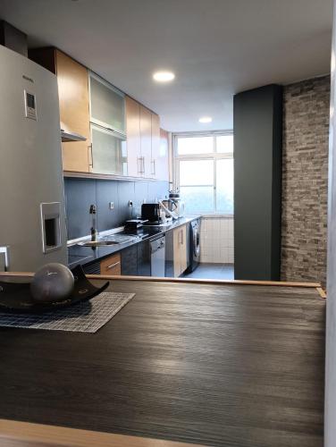 a large kitchen with a wooden counter top at BeauTour in Sacavém