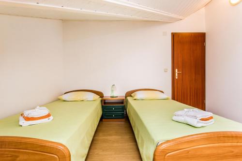 two beds sitting next to each other in a room at Guest house Lavanda 4 in Njivice