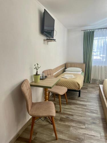 a living room with a table and chairs and a couch at La Turcu in Văliug