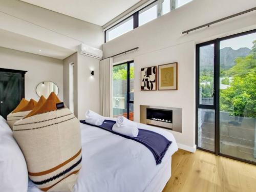 a bedroom with a large bed and a fireplace at Luxurious Family home in Newlands with Pool in Cape Town